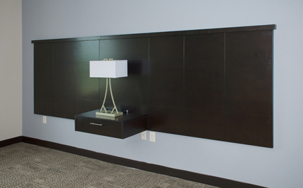 Custom built hotel Bar features wood framework, bar surface of translucent glass, and mosaic tile decorative facing.