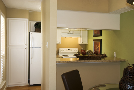 After: Refreshingly attractive remodeling of pantry and cabinets featuring traditional high gloss white windowpane door facings with granite-style laminate breakfast bar countertop.