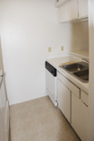 Before: Badly worn cabinets and countertops were stripped, sanded and refinished. Cabinets were refaced with attractive raised panel picture frame style doors featuring concealed compact hinges and brushed nickel handles and knobs. Countertops were resurfaced with upscaled granite-style laminate.