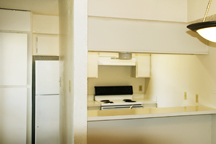 Before: Nearly unleasable Worn and dated particle board pantry and cabinets and white formica countertop.