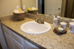 After: Bonier's bathroom update adds appealing value for tenant and owner alike. Resurfaced countertops with granite-style laminate and painted white, raised-panel cabinetry and doors create a refreshing feeling to the apartments.