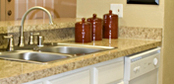 Two-level kitchen sink cabinet with granite style laminate countertop upgrade for commercial apartment renovation