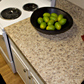 Attractive granite countertop replacement with raised panel doors cabinets painted with distinctive traditional white gloss enamel