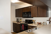 After: Suspended cabinets stripping, sanding, staining, and refinishing for stylish modern appeal.