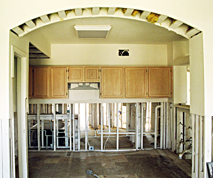 Before: Countertop and Sink Cabinets were removed, mold treated and eliminated, and then rebuilt and finished to match kitchen cabinetry which was stripped, sanded, stained, refaced, and refinished.